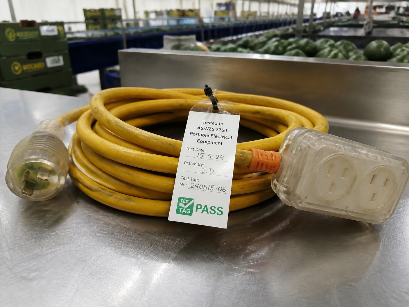 Extension lead with a completed electrical test tag on a packhouse bench